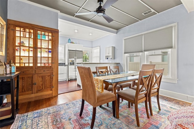 dining space featuring wood-type flooring and ceiling fan