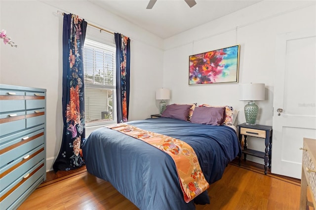 bedroom with hardwood / wood-style flooring and ceiling fan