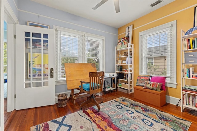 living area with ceiling fan and dark hardwood / wood-style floors