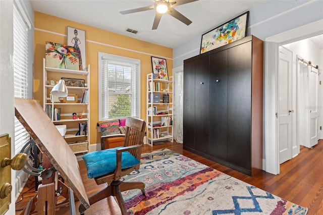 sitting room featuring dark hardwood / wood-style floors and ceiling fan