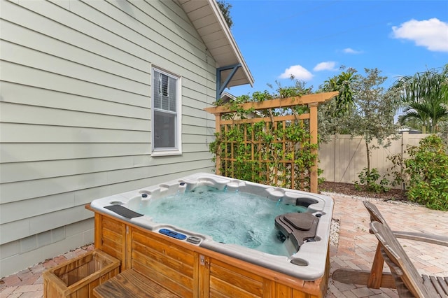 exterior space featuring a hot tub, a grill, and a patio area