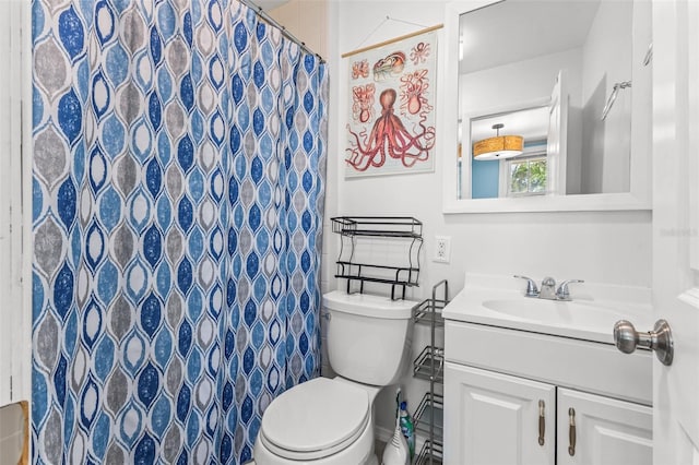 bathroom with vanity, a shower with shower curtain, and toilet