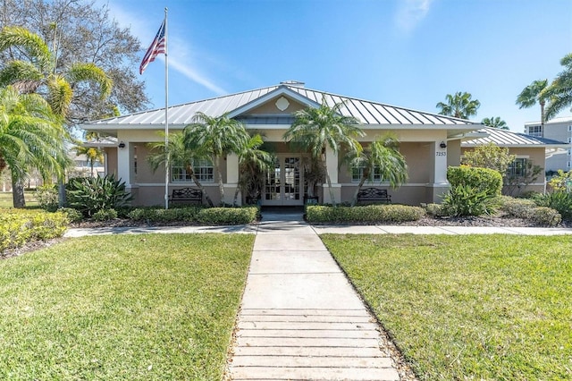 view of front of property featuring french doors and a front lawn