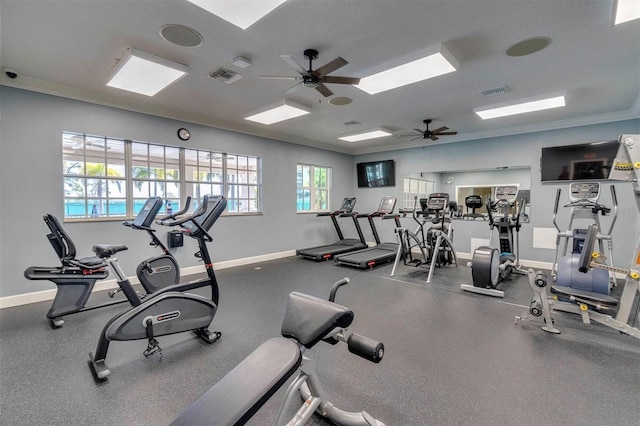 exercise room with ceiling fan and crown molding