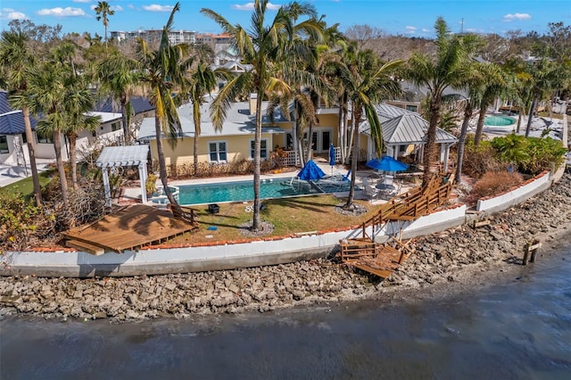 view of pool featuring a water view and a patio