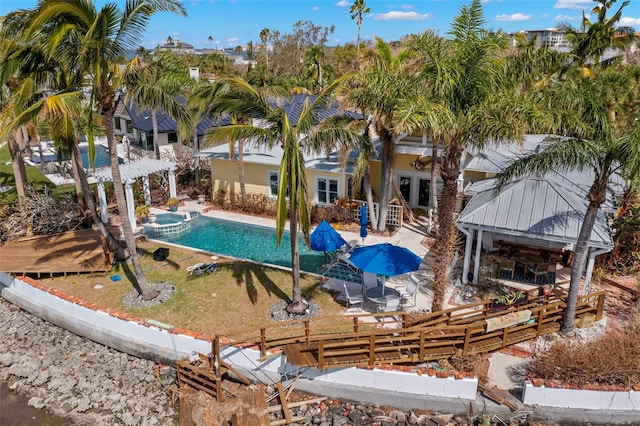 view of swimming pool featuring an in ground hot tub