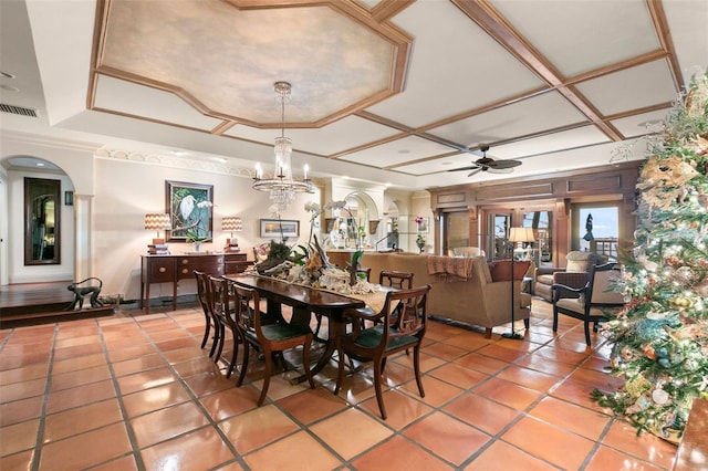 dining room featuring tile patterned floors, ceiling fan with notable chandelier, crown molding, and coffered ceiling