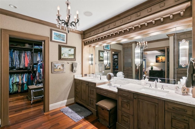 bathroom featuring an inviting chandelier, vanity, and hardwood / wood-style flooring