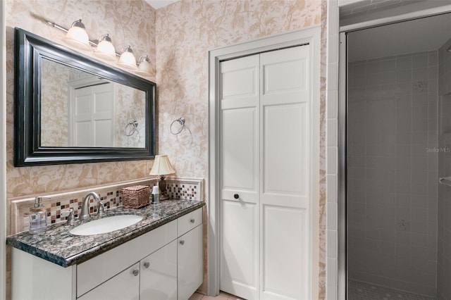 bathroom with vanity, tasteful backsplash, and an enclosed shower