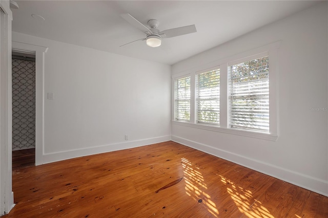 empty room with ceiling fan and wood-type flooring