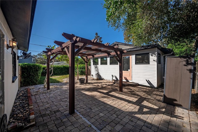 view of patio with a shed and a pergola