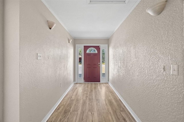 doorway featuring wood-type flooring and ornamental molding