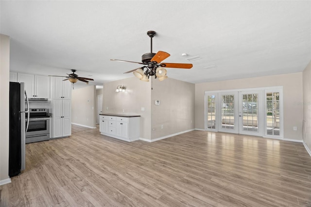 unfurnished living room featuring ceiling fan, french doors, and light wood-type flooring