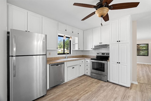 kitchen with ceiling fan, sink, light hardwood / wood-style floors, white cabinets, and appliances with stainless steel finishes