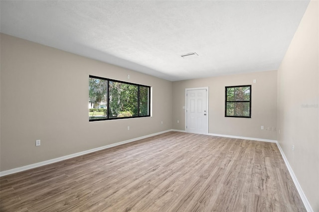 empty room with light hardwood / wood-style flooring