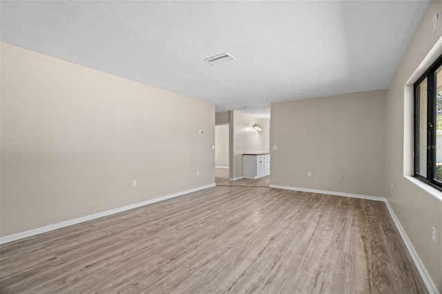 unfurnished living room featuring light hardwood / wood-style floors