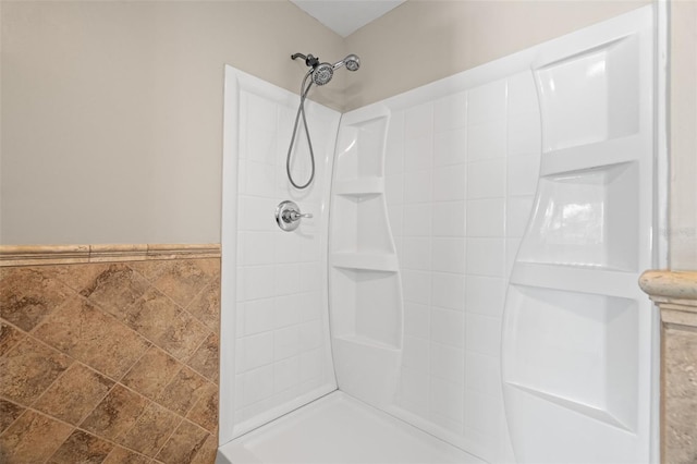 bathroom featuring tile walls and tiled shower