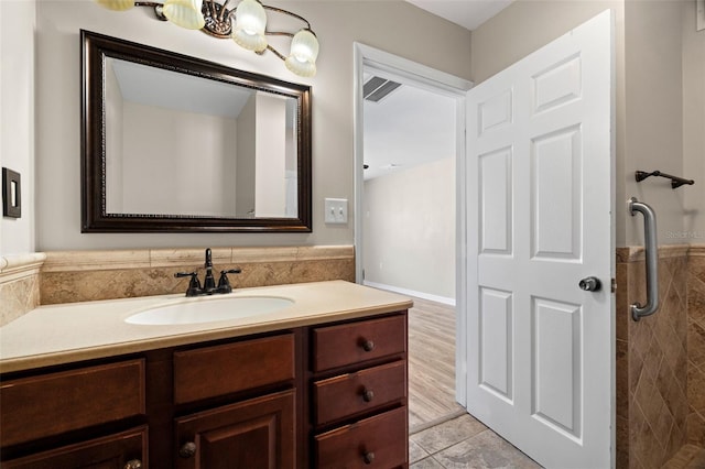 bathroom with a shower, vanity, and wood-type flooring