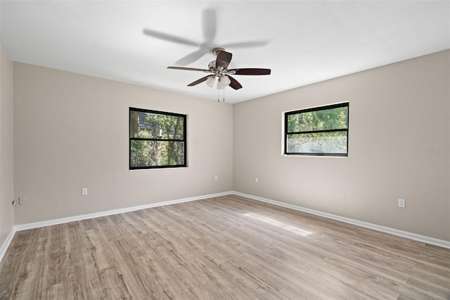 unfurnished room with ceiling fan, light hardwood / wood-style floors, and a wealth of natural light