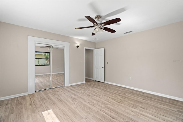 unfurnished bedroom with ceiling fan, a closet, and light hardwood / wood-style floors