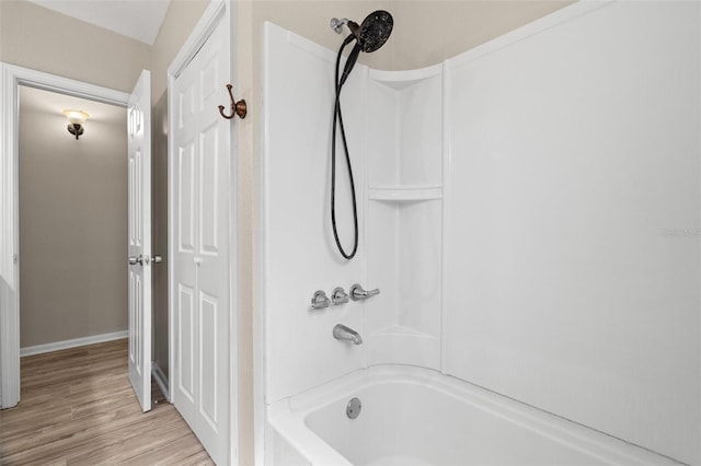 bathroom featuring hardwood / wood-style floors and shower / tub combination