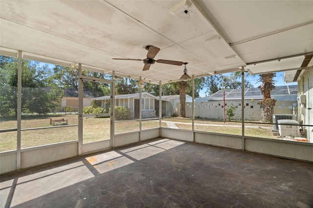 unfurnished sunroom featuring ceiling fan