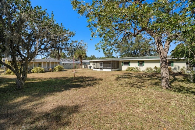 view of yard with a sunroom and glass enclosure