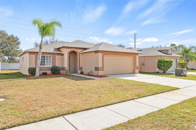 view of front of property with a front yard and a garage