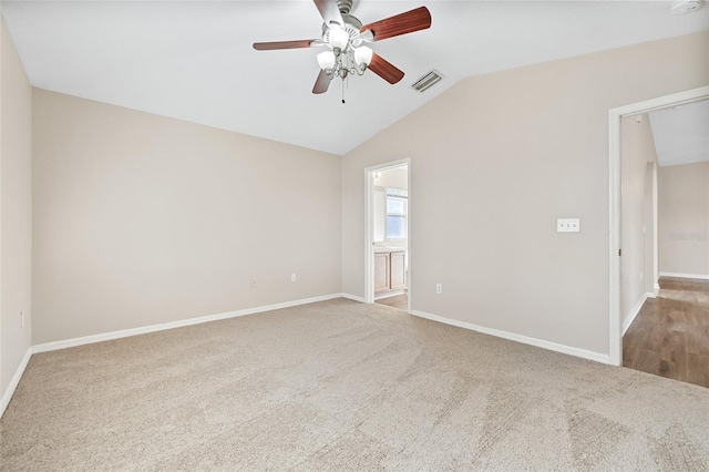 carpeted empty room with ceiling fan and lofted ceiling