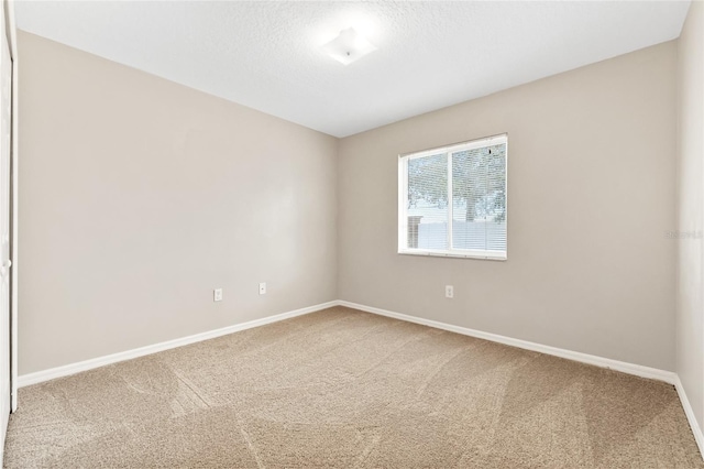 carpeted spare room featuring a textured ceiling