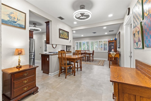 dining area with light tile patterned floors and ceiling fan