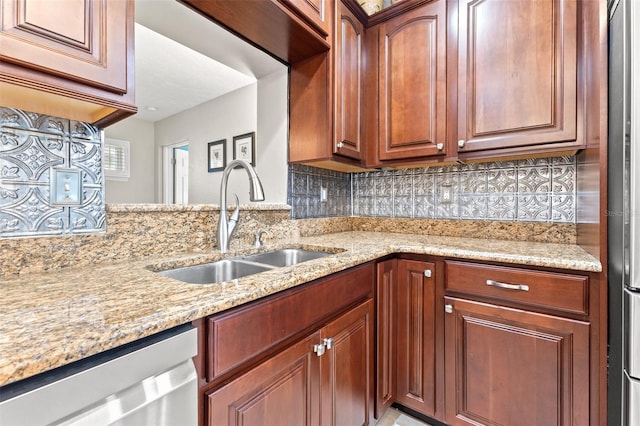 kitchen featuring sink, dishwasher, light stone countertops, and tasteful backsplash