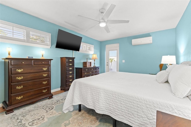 bedroom with ceiling fan and a wall mounted AC