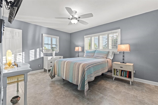 bedroom featuring multiple windows, tile patterned floors, and ceiling fan