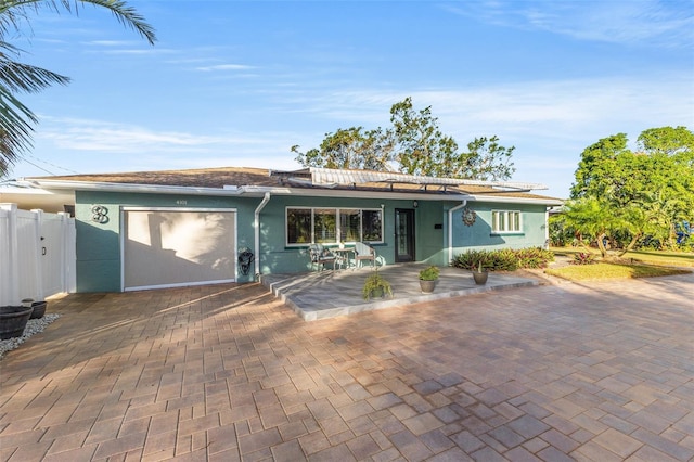 ranch-style home featuring a garage