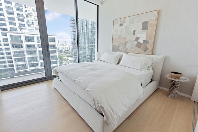 bedroom featuring light hardwood / wood-style flooring and access to exterior