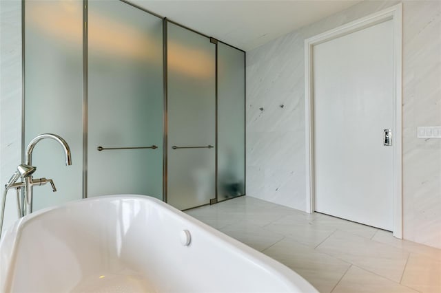 bathroom featuring a tub and tile patterned flooring