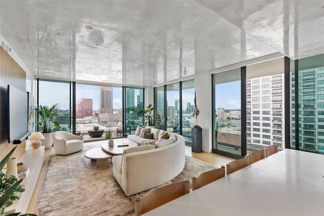 living room featuring wood-type flooring and floor to ceiling windows