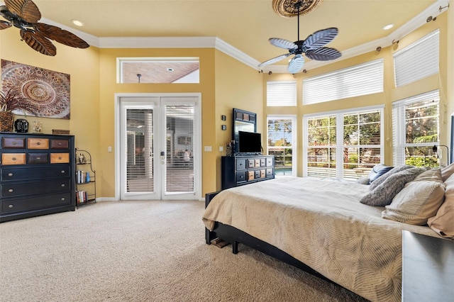 bedroom with carpet floors, crown molding, access to exterior, a high ceiling, and ceiling fan