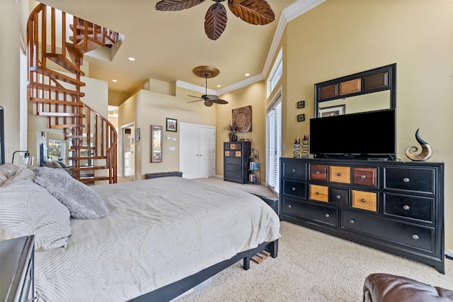 bedroom with carpet floors, multiple windows, crown molding, and ceiling fan