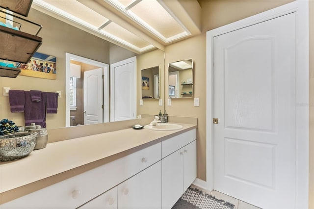 bathroom featuring toilet, vanity, and tile patterned flooring