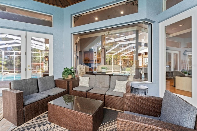 view of patio with a lanai, outdoor lounge area, and french doors