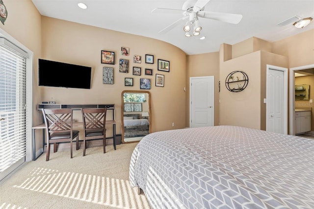 carpeted bedroom with connected bathroom and ceiling fan