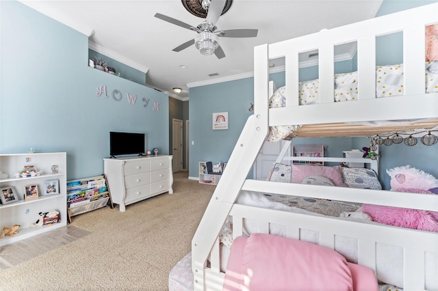 bedroom with crown molding, ceiling fan, and carpet floors