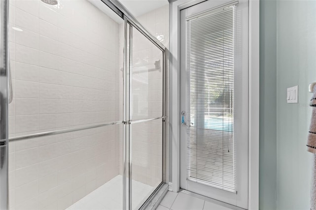 bathroom featuring tile patterned flooring and a shower with door