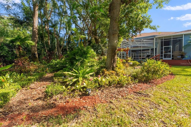 view of yard with a sunroom and glass enclosure