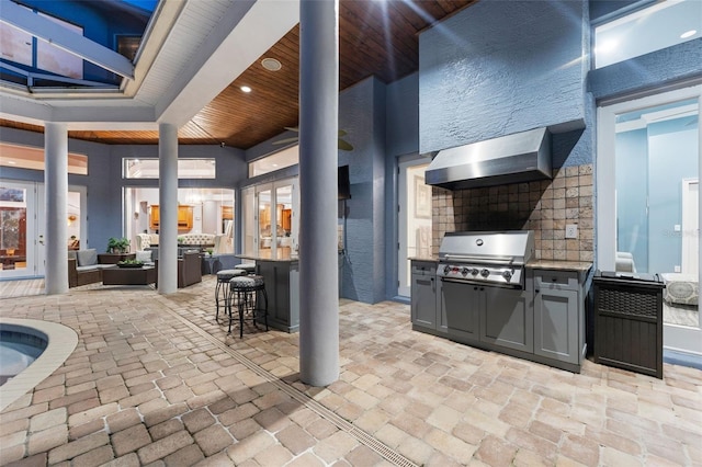 view of patio / terrace with exterior kitchen, area for grilling, and an outdoor bar