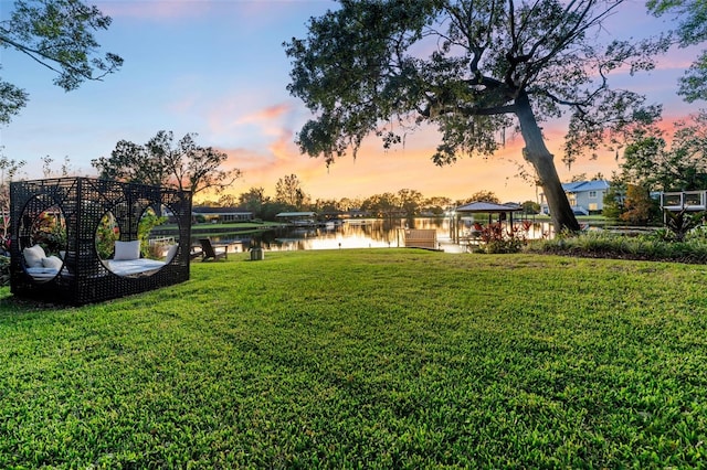 yard at dusk with a water view