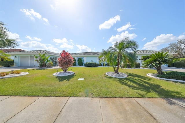 view of front facade featuring a garage and a front lawn