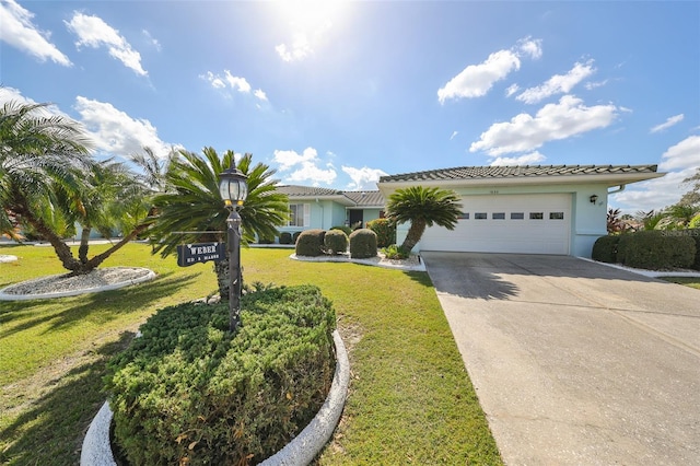 view of front of house featuring a front yard and a garage